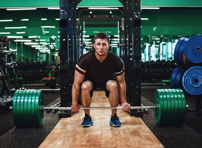 man using a weightlifting platform to perform a deadlift