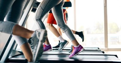 close up of peoples legs running on treadmills