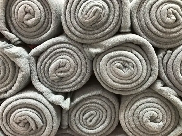 rolled up grey blankets
