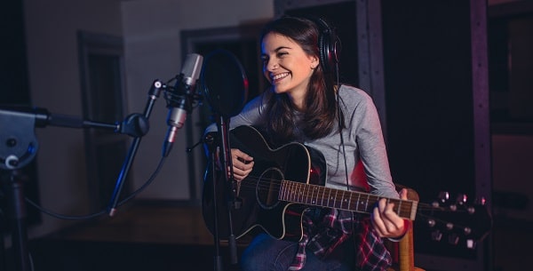 singer playing song in recording studio