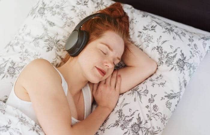 girl sleeping wearing noise cancelling headphones