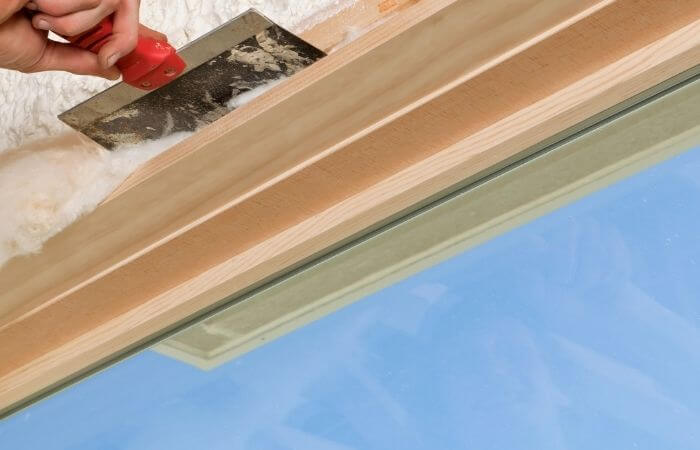 fitting fiberglass insulation around a window frame