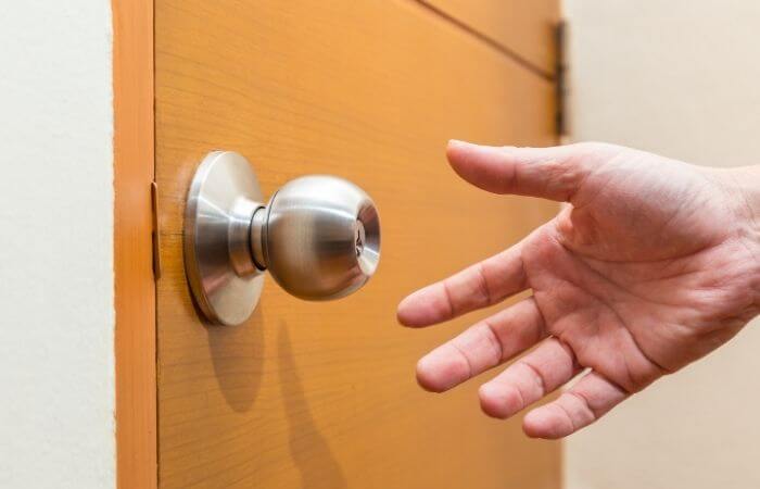 hand reaching for door knob
