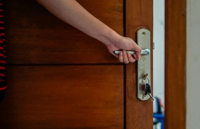 lifting a door up by the handle can reduce squeaking